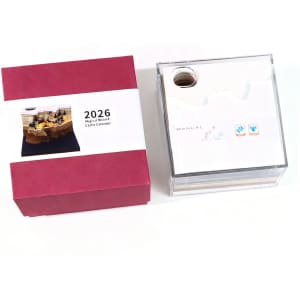 A 3D paper carving notepad with a clear exterior, featuring a manual on top, alongside a red box.
