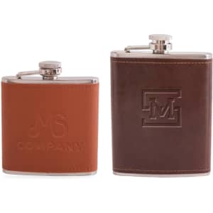 A drink bottle featuring two classic hip flasks in brown leather and stainless steel, each with distinct engravings and branding.