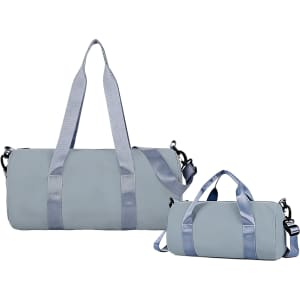 A light blue bucket duffle bag featuring wide straps, with a larger and smaller size displayed. Includes a logo.