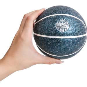 A person's hand holds a dark blue mini basketball with white lines and a logo on the surface.