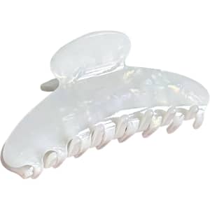 An acetate hair clip in a pearlescent white colour, featuring a curved design with multiple grip teeth.