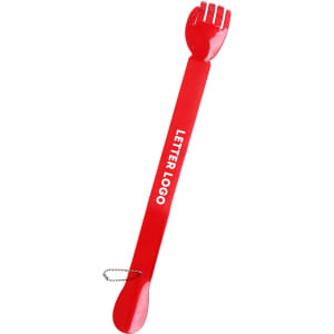 A red back scratcher and shoehorn with a forked end and a circular handle, featuring a logo.
