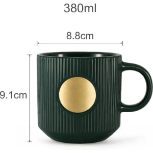 A green ceramic mug featuring a textured design and a bronze medal in the centre, with a capacity of 380ml.