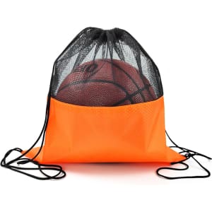 An orange drawstring mesh backpack with a black top, holding a basketball inside. It features a logo.