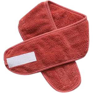 A promotional headband in a coral colour, featuring a soft, textured fabric and a logo.