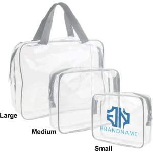 Three clear toiletry bags in varying sizes: large, medium, and small, all with grey trim and handles. One bag features a logo.