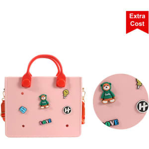 A pink tote bag with red handles featuring decorative stickers and a logo. The bag has a playful design and visual details.