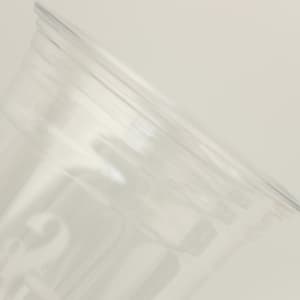 A clear plastic cup with a smooth finish, featuring a subtle logo design on the side.