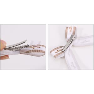 A hair clip bow with a white and brown patterned ribbon and a silver clip. The design features a double loop.