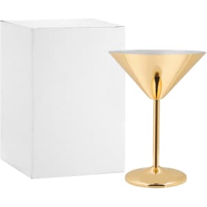 A stainless steel martini goblet in a shiny gold finish, beside a white box.
