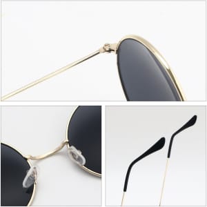 Retro round sunglasses with black lenses and a gold frame, featuring clear nose pads and sleek black arms.