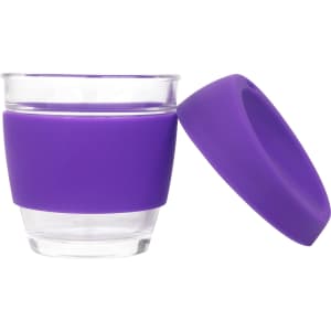 A reusable glass coffee cup with a purple silicone sleeve and matching lid. Features a clear glass body.
