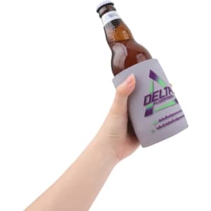 A drink bottle is held in a grey stubby holder featuring a logo. The holder is designed to keep beverages cool.