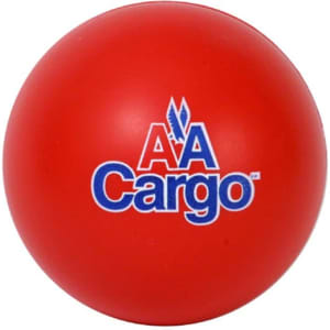 A red, round stress ball in the shape of a baseball, featuring a logo on the surface.