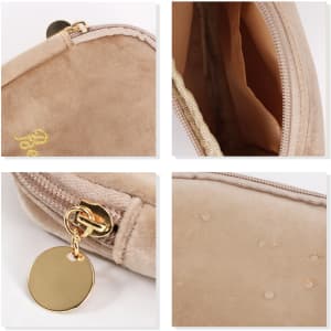A stylish mini makeup bag in beige suede with a gold zip and tag, featuring a smooth interior and soft texture.
