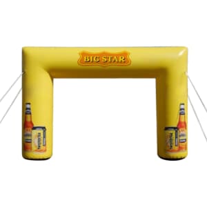 An inflatable yellow event arch featuring two drink bottles and a logo. Ideal for exhibitions and events.
