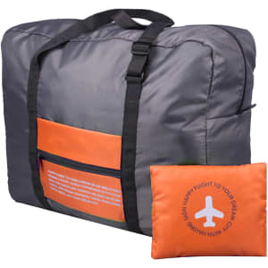 A grey travel compressed bag with an orange pocket and strap, alongside a matching compressed cushion.