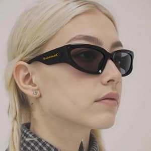 Wraparound sunglasses with a black frame and dark lenses, featuring a logo on the side.