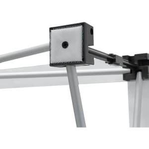 A close-up of a fabric popup display frame, featuring grey metal components and a textured connector.