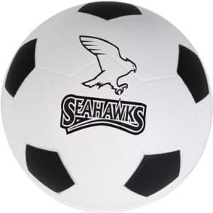 A white football-shaped stress reliever with black patches and a logo featuring an eagle.