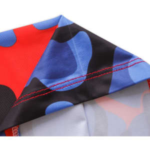 A Polyester neck gaiter featuring a vibrant pattern of red, blue, and black colours with visible stitching.