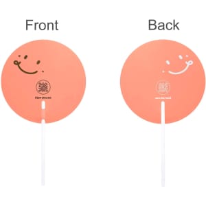 A transparent PVC hand fan in a round shape, featuring a pink-orange colour with smiley designs on both sides.