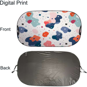 A light-blocking car sun shade featuring a colourful, abstract design on the front and a black back.