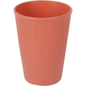 A wheat straw toothbrush cup in a coral colour with a ribbed texture and a logo.