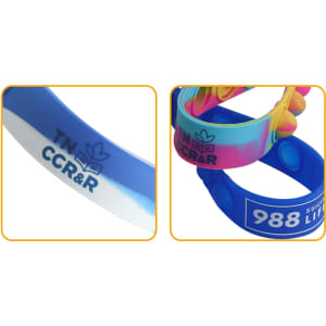 Colourful silicone wristbands with varied designs, featuring different blue shades and a logo.