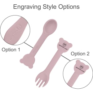 A pink silicone kids cutlery set featuring a spoon and fork with bear-shaped handles, displaying engraving style options.