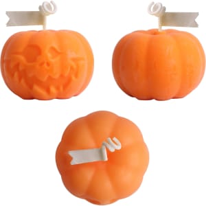 Orange pumpkin-shaped candles with white decorative tags, featuring a smiling and a spooky face design.
