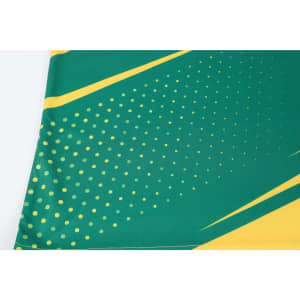 A green and yellow sublimated sports long sleeves shirt featuring a dotted design and angled stripes, with a logo present.