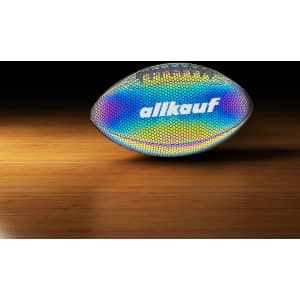 A holographic glowing American football with a reflective surface, featuring a logo, on a wooden surface.