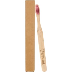 A bamboo toothbrush with a large flat handle and pink bristles, packaged in a brown cardboard box.
