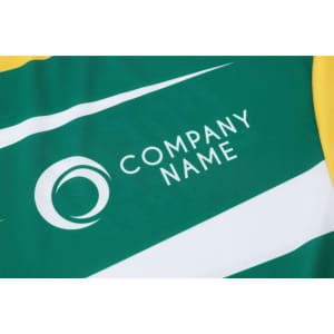 A green and yellow long-sleeved sports shirt featuring a logo and simple striped design.