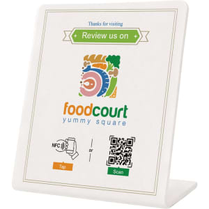 A white NFC review stand displaying instructions to tap or scan for reviews, featuring a logo and colourful graphics.