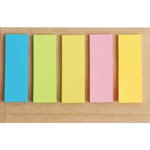A set of five notepad strips in blue, green, yellow, pink, and orange on a brown background.