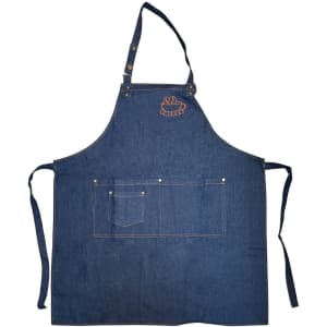 A denim blue full bib apron with a neck strap and front pockets, featuring a logo on the chest area.
