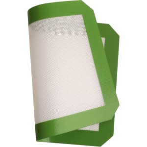 A silicone baking mat in green with a textured white surface, featuring rounded edges.
