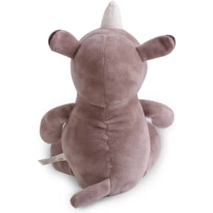 A grey rhinoceros plush toy with a white horn, sitting upright and facing away from the viewer.