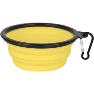 A collapsible silicone bowl in yellow with a black rim and a carabiner attached for easy carrying.