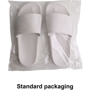 White PVC slides packaged in a clear plastic bag. The footwear has a simple design with two wide straps.