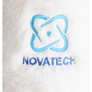 A plush toy with soft white fur featuring an embroidered blue and dark blue logo.