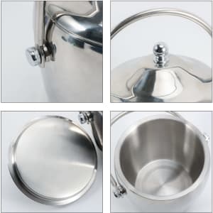 A shiny stainless steel cooler bucket with a handle and a lid, featuring a smooth, polished interior.