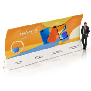 A U-shaped fabric display wall in orange and white featuring smartphone images and a logo, with a person standing beside it.