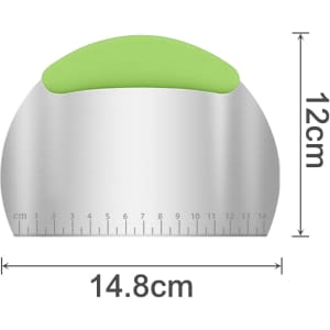 A stainless steel flour cutter with a green handle, featuring measurement markings and dimensions of 14.8 cm by 12 cm.