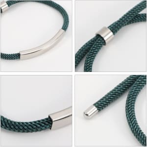 A metal woven bracelet featuring a dark green woven design and sleek silver accents.