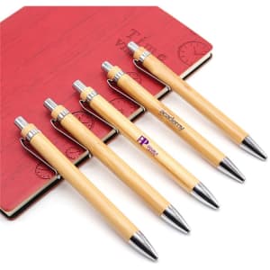 Five eco bamboo pens with silver accents are arranged next to a red notebook, featuring a logo on the pens.