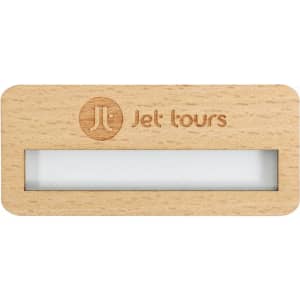 A reusable wooden name badge in light wood with a clear window and a logo.