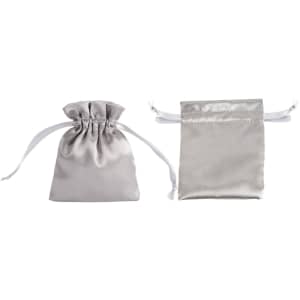 Two silver silk satin drawstring bags, one standing upright and the other lying flat, both featuring white drawstrings.